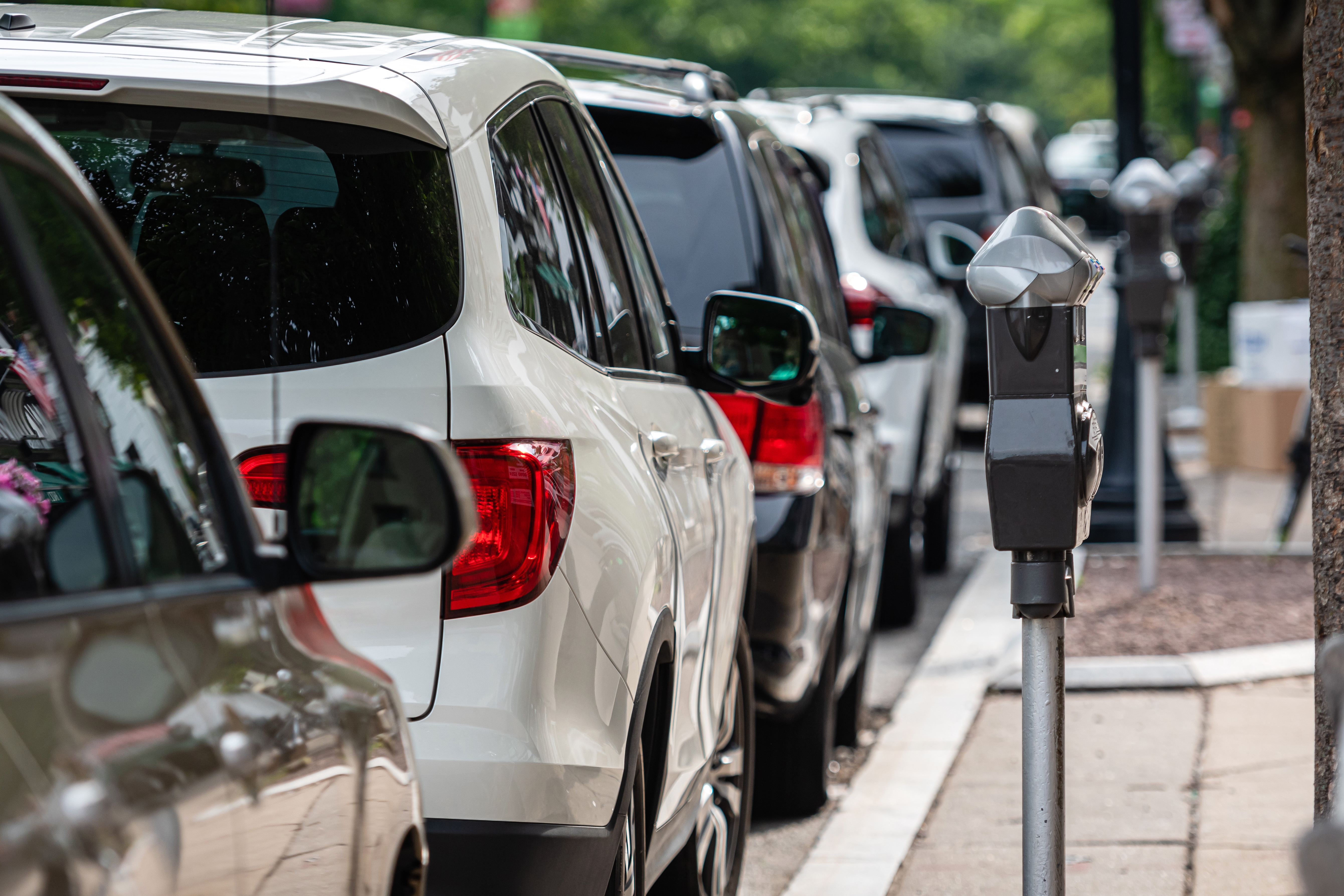 Cars Parked Along City Street With Parking Meters