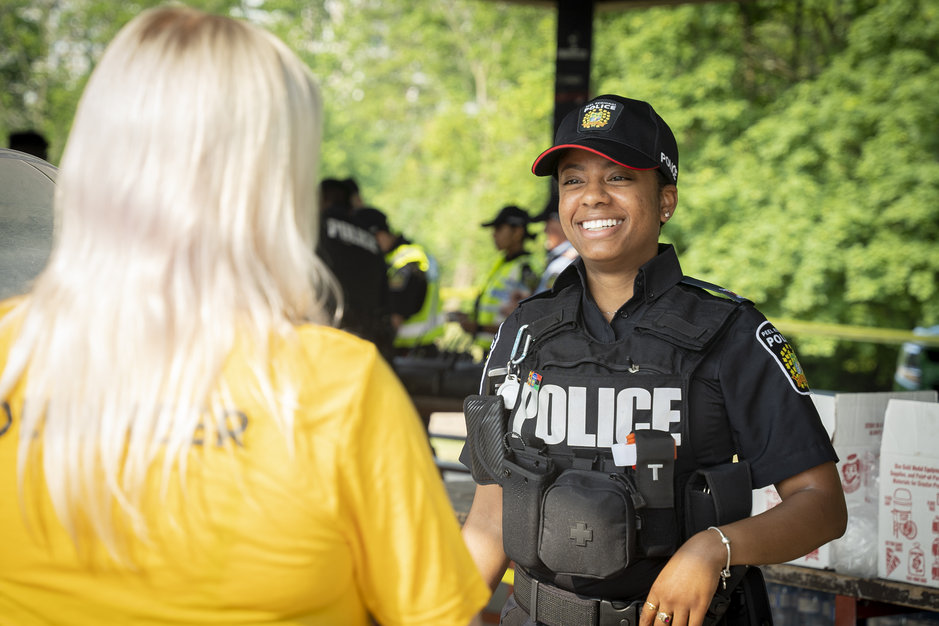 Female police officer smiling and listening to citizen