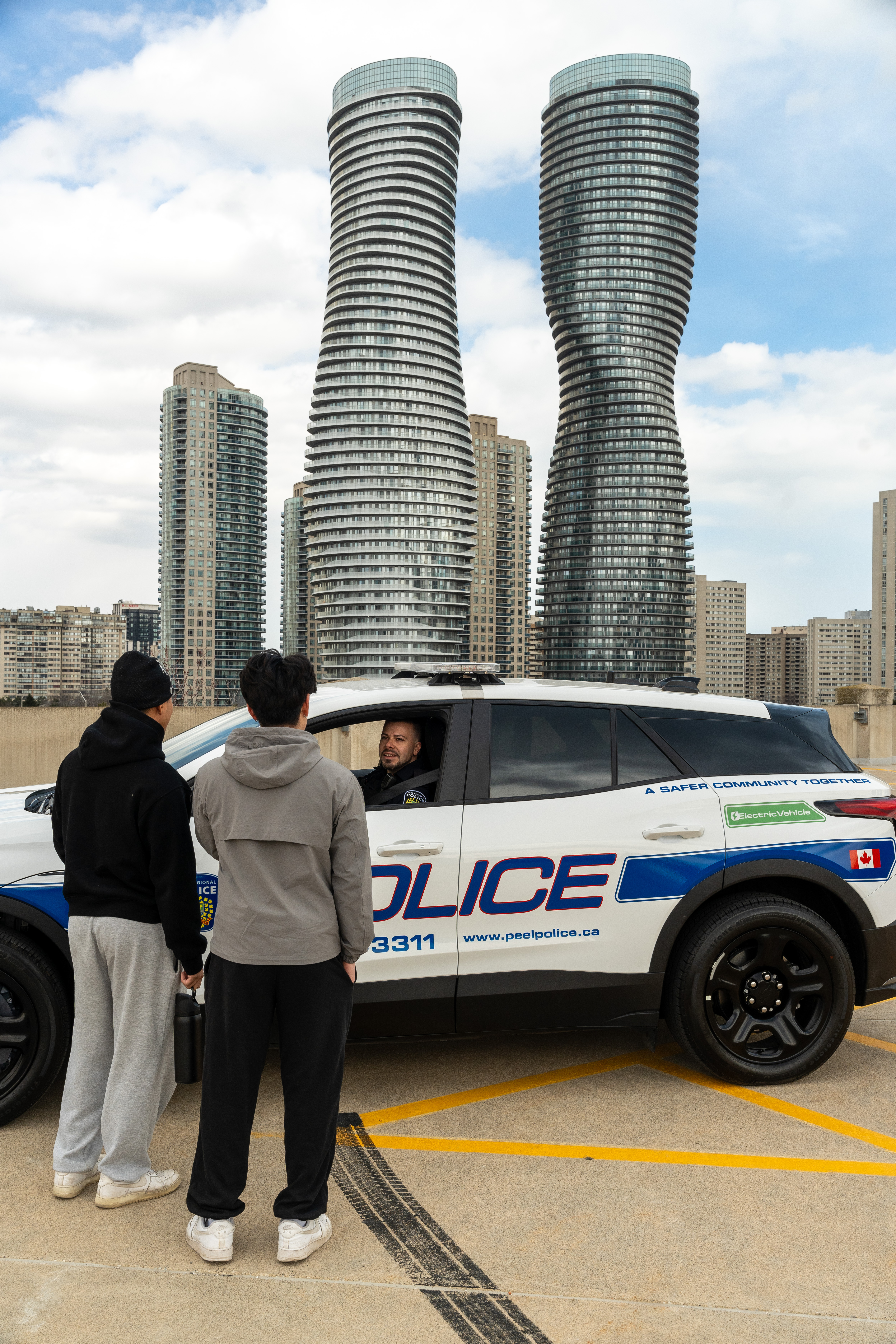 Police officer talking to youth from Chevy Blazer EV