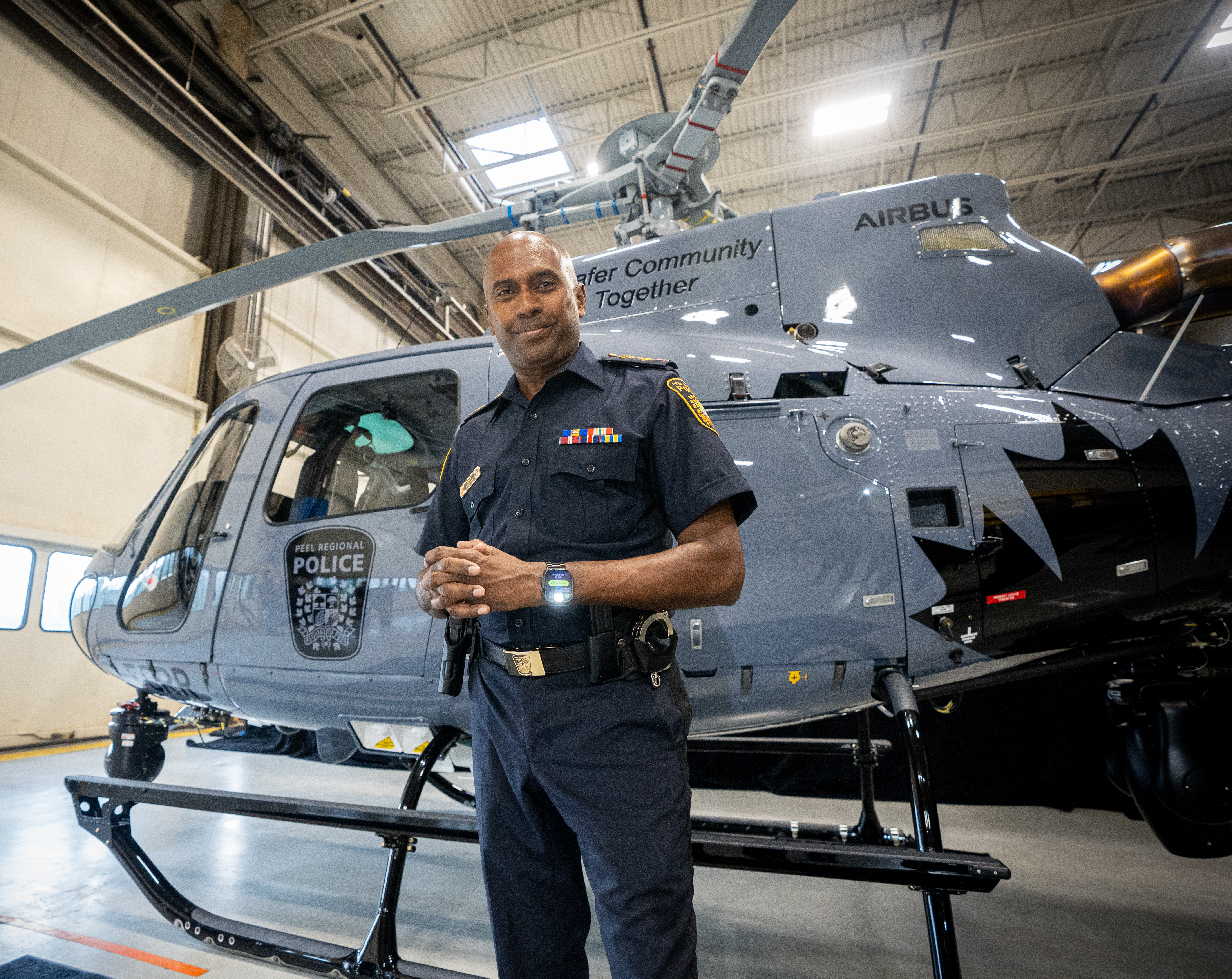 Chief of Police with helecopter in hangar
