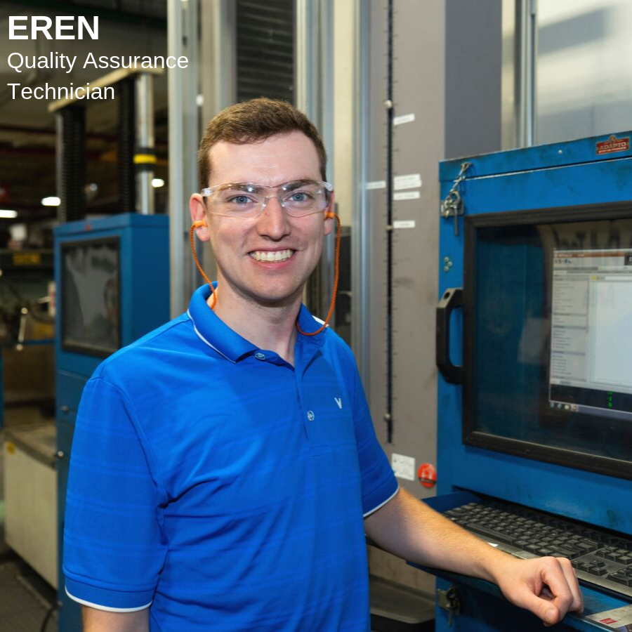 Man standing beside a computer