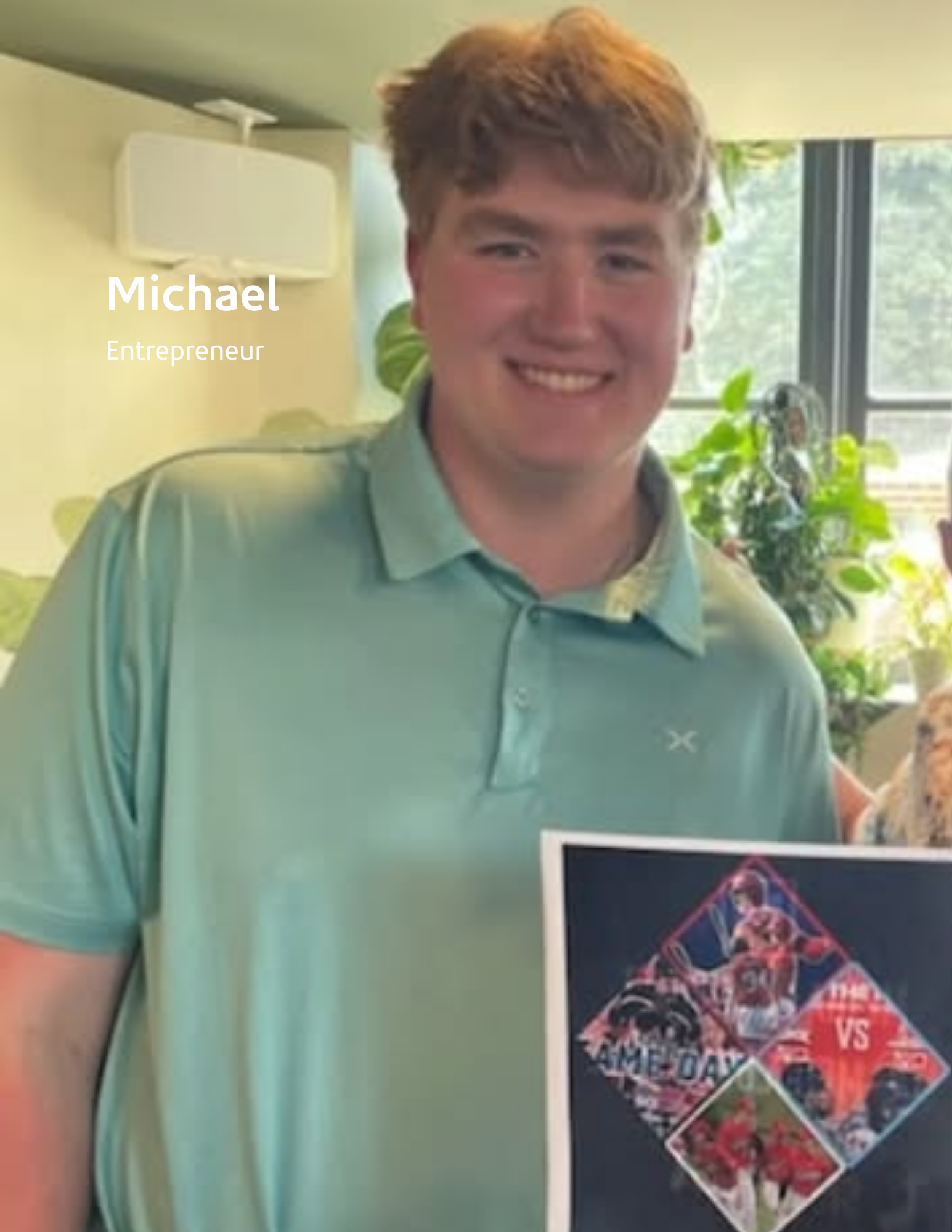 young man posing inside a cafe holding a piece of paper