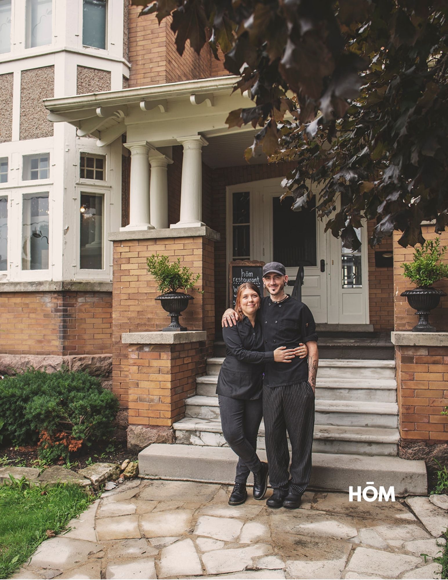 Two People Standing Infront of Hom Restaurant