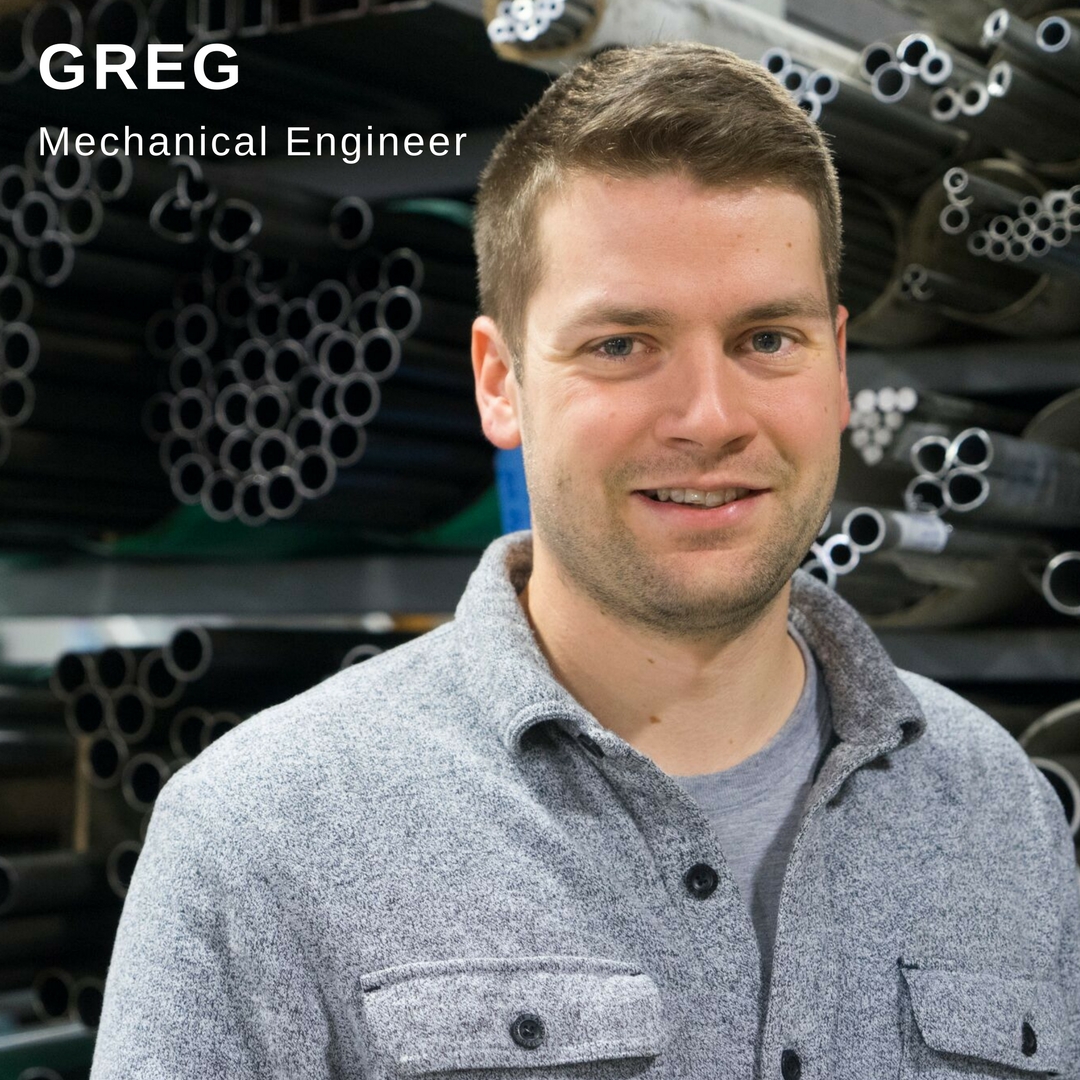 Young man standing in front of building equipment