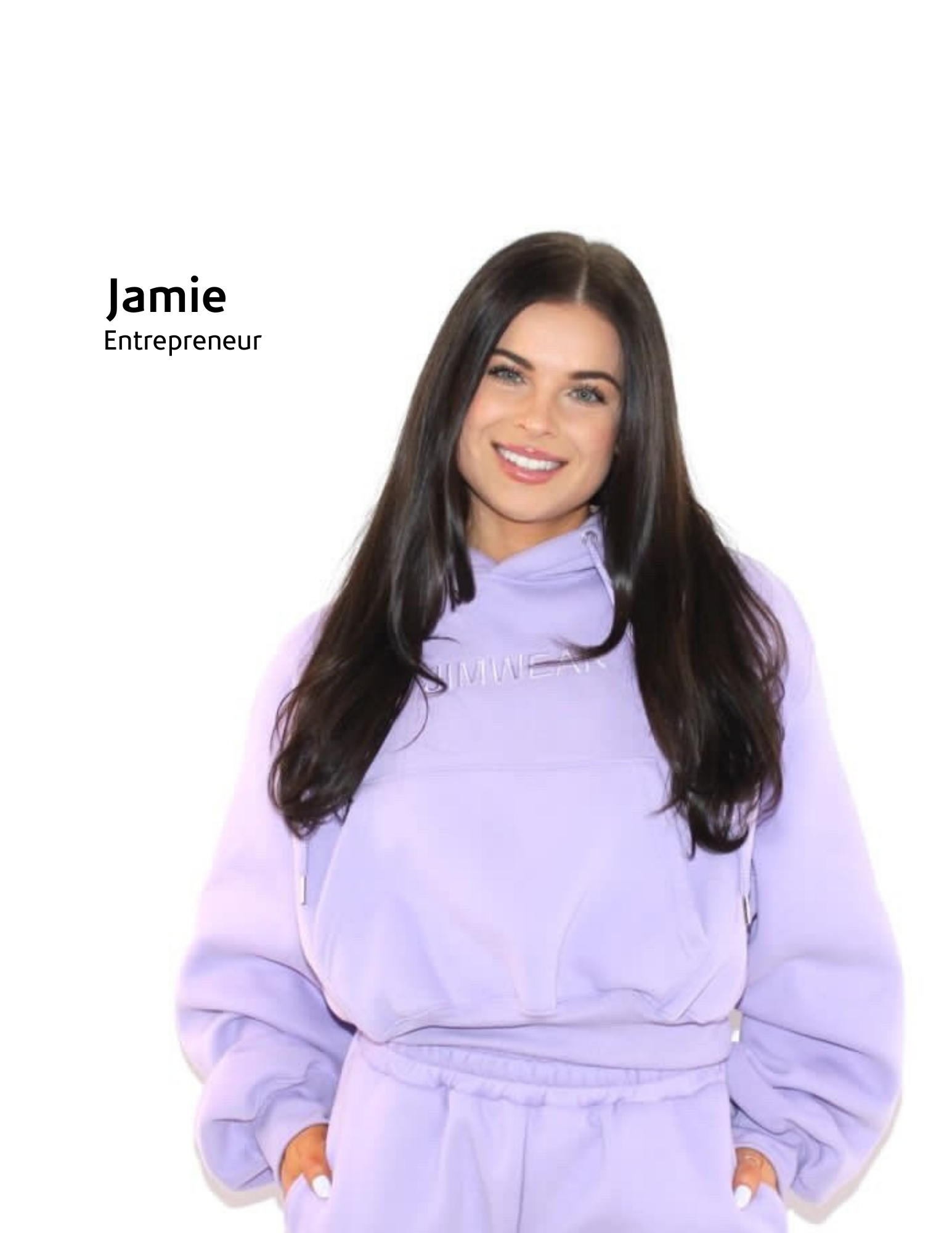 woman posing in a tracksuit on a blank wall