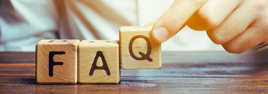 Image of a hand placing blocks with FAQ letters on a table