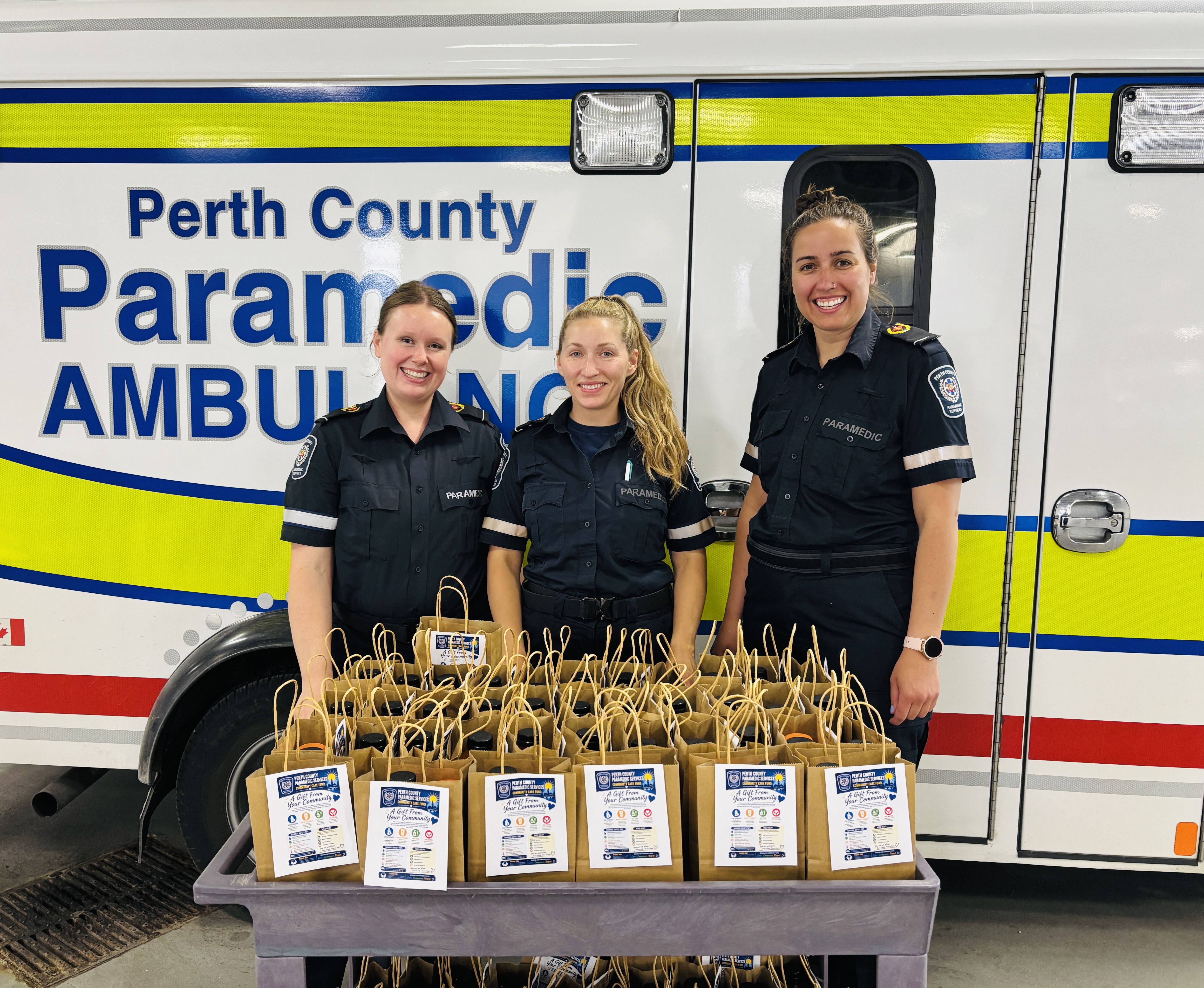 Group of 3 paramedics standing in front of care kits