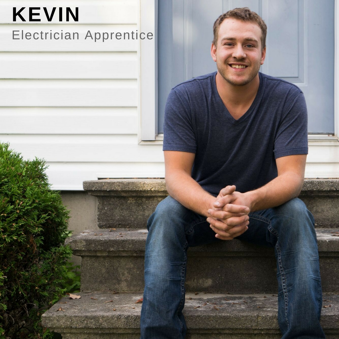 Young man sitting on front steps of a house