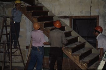 men in hard hats building stairs