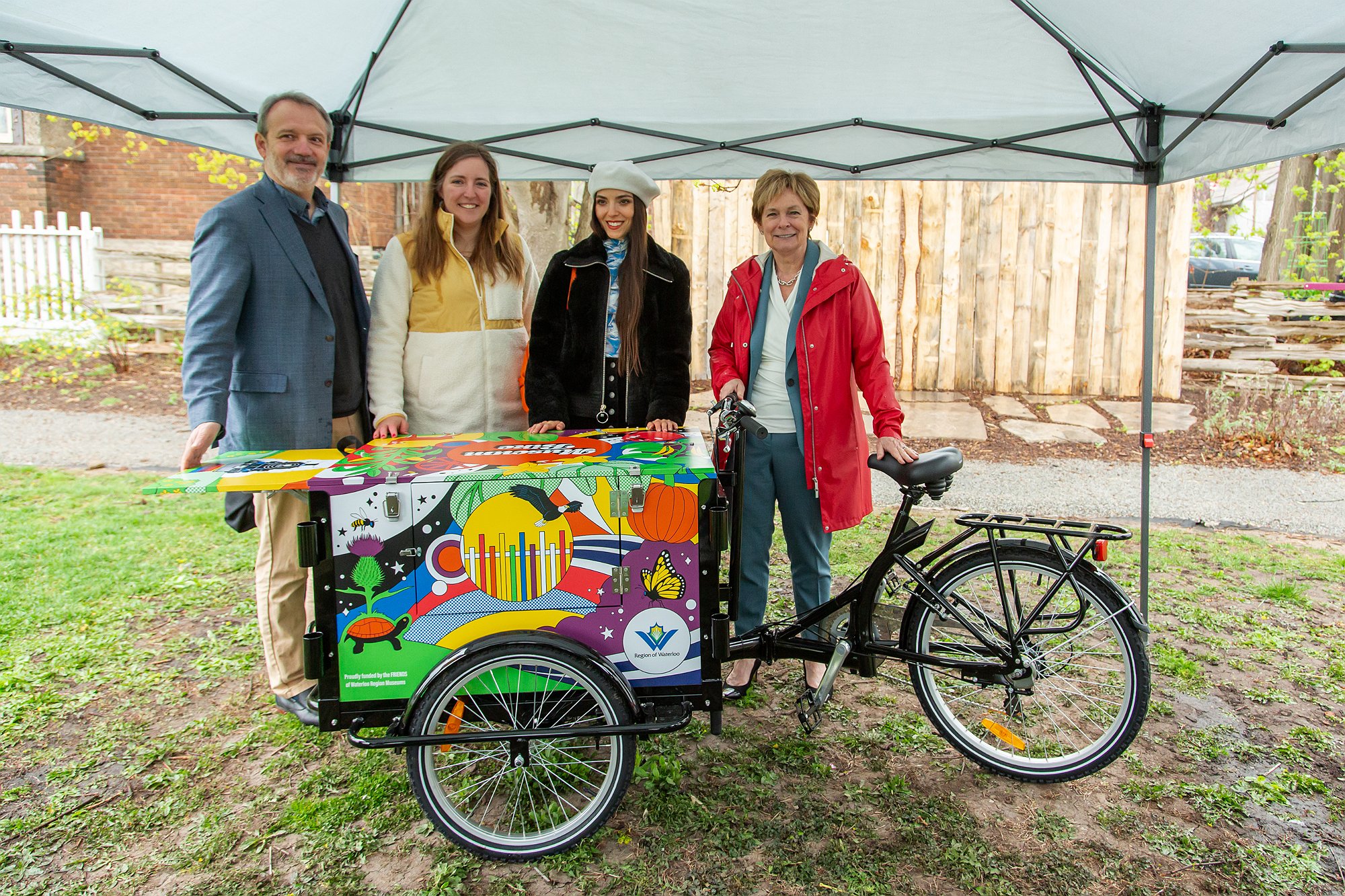 Julian Kingston, Stephanie Scott and Chair Redman stand behind the bike