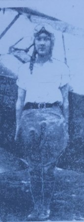 Mary Weber standing in front of plane