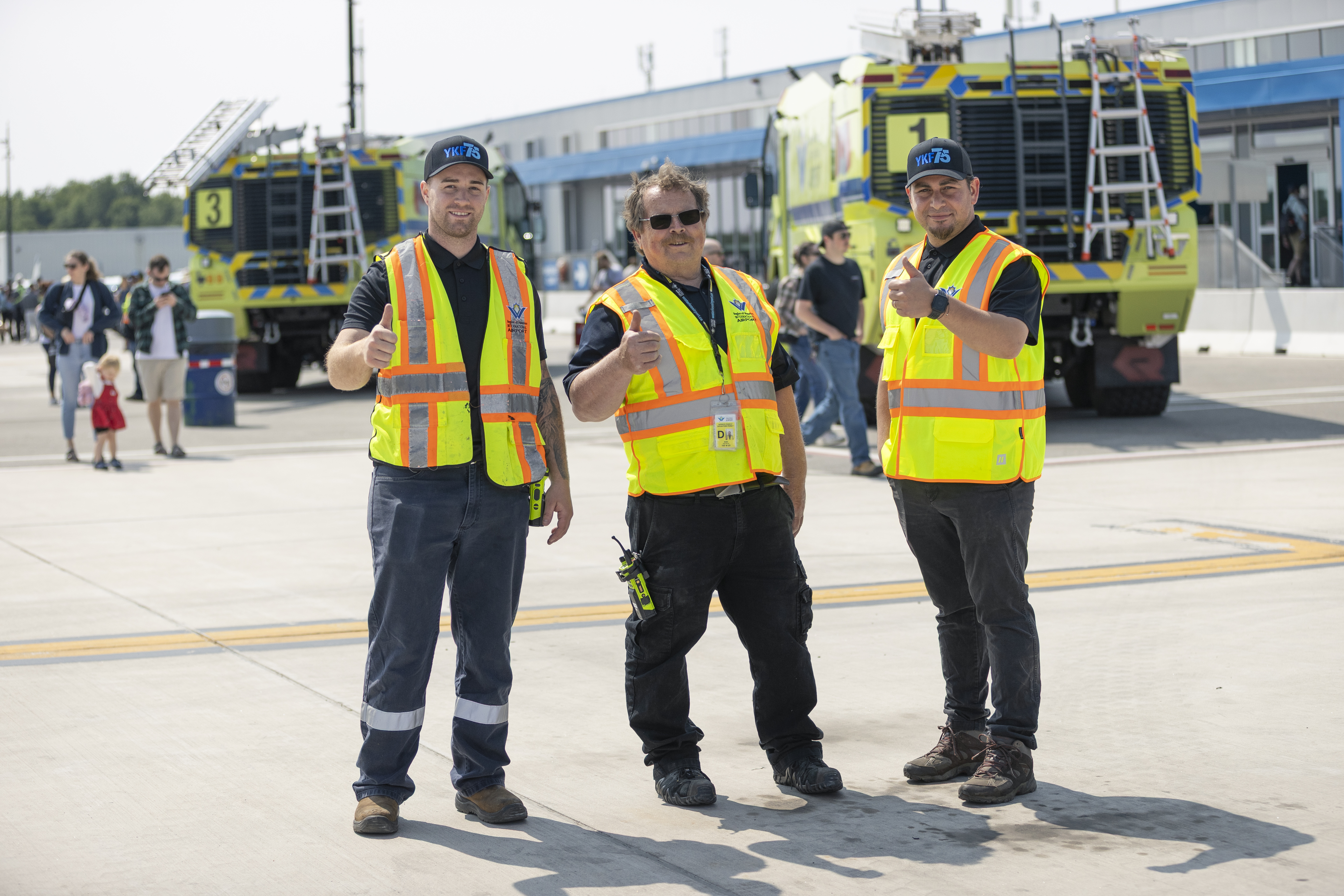 Three members of the YKF team giving a thumbs up 