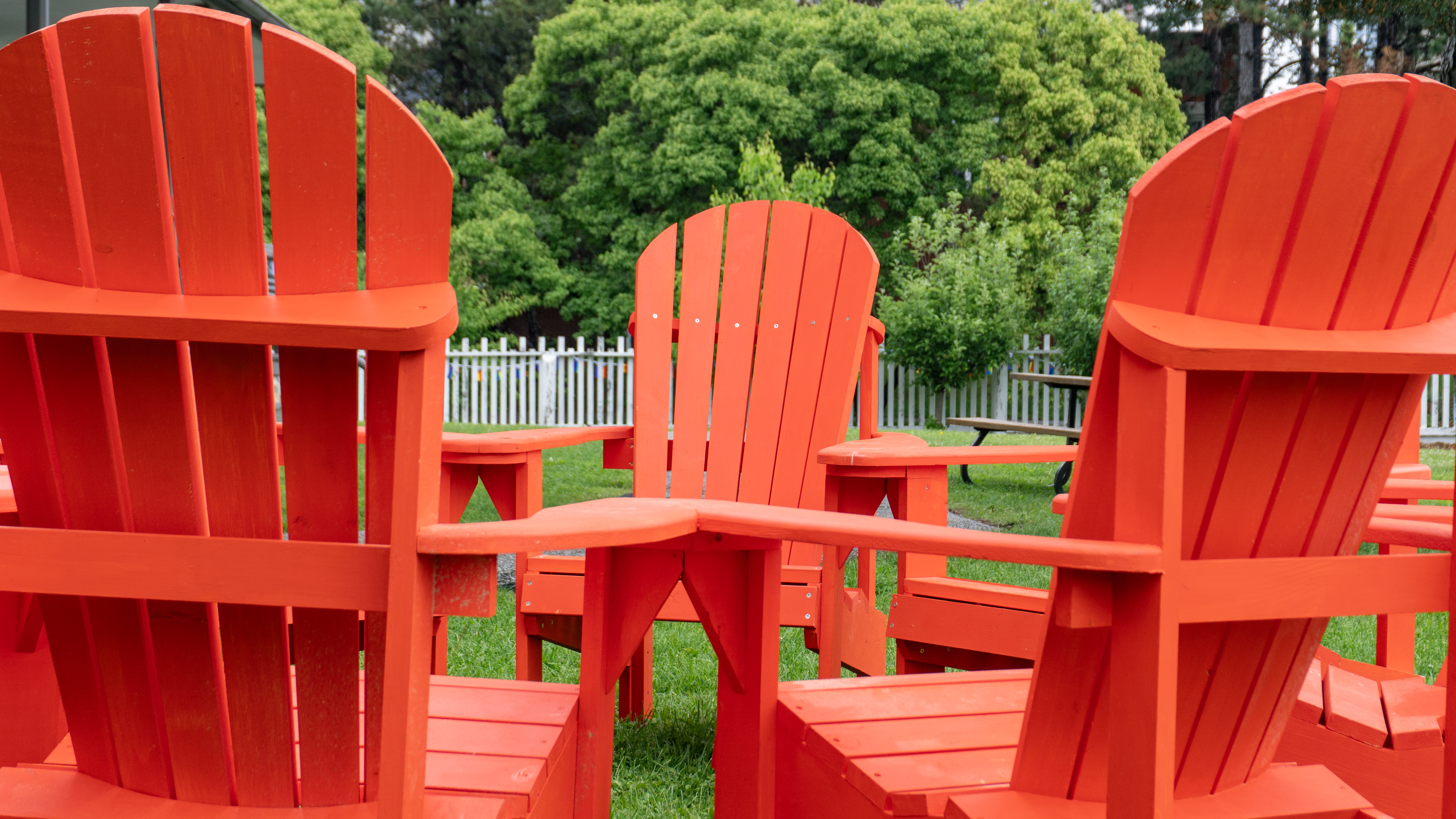 Adirondack chairs arranged in a tight circle together