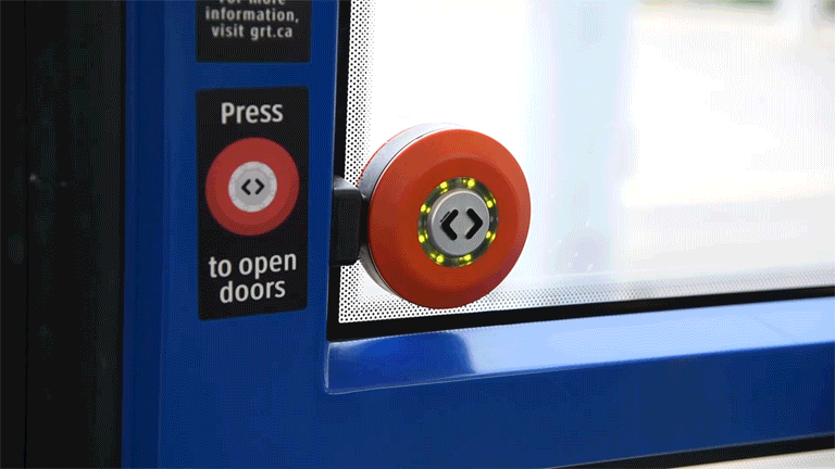 hand pressing button to open doors