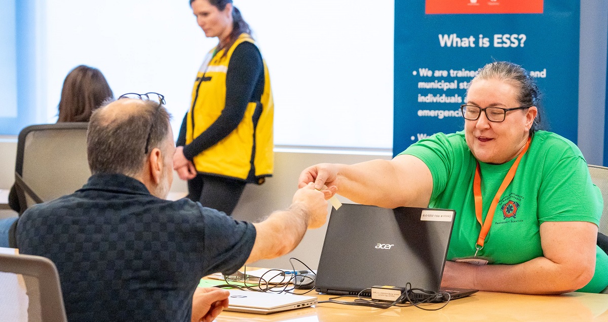 A volunteer helps an evacuee