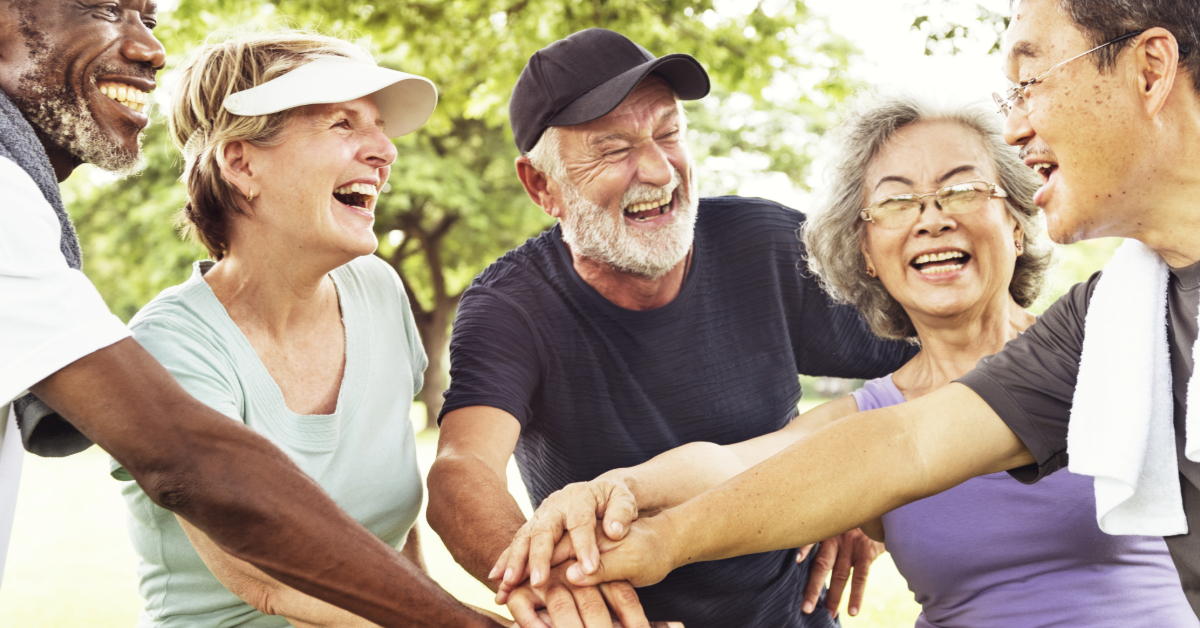 A group of older adults celebrate a sports win.