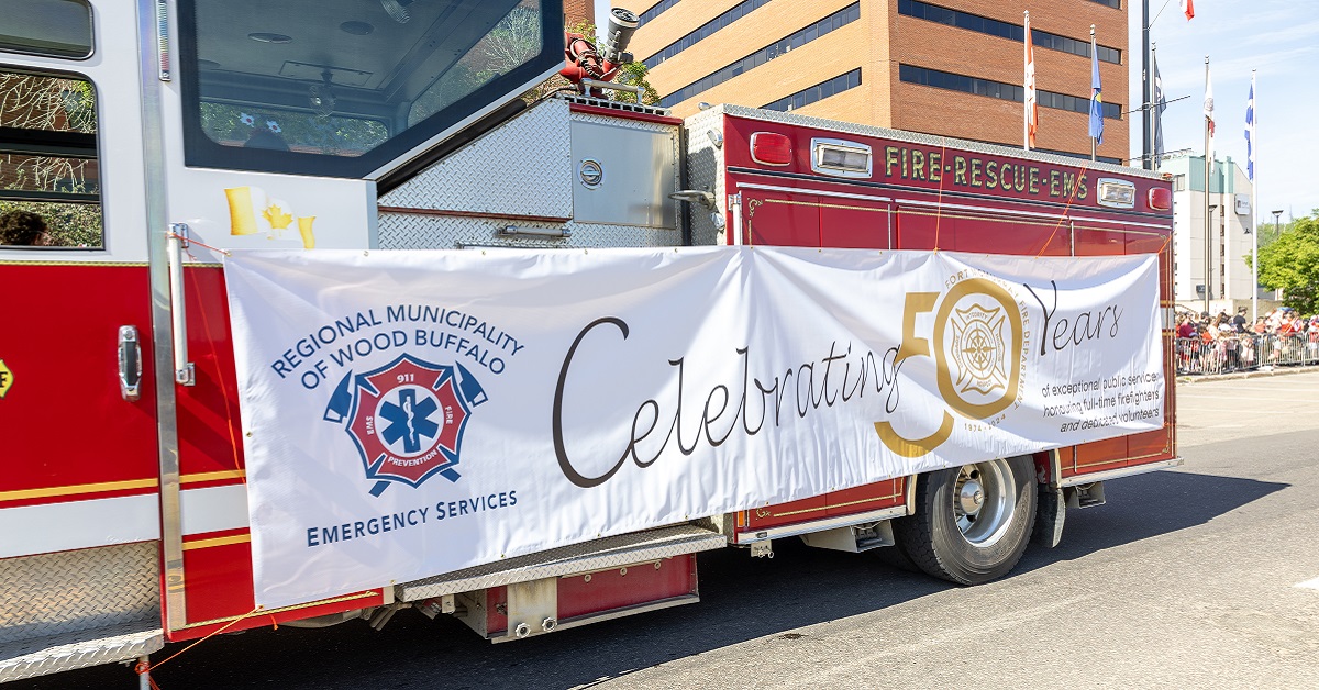 A fire truck in the Canada Day parade displays a 50th anniversary banner