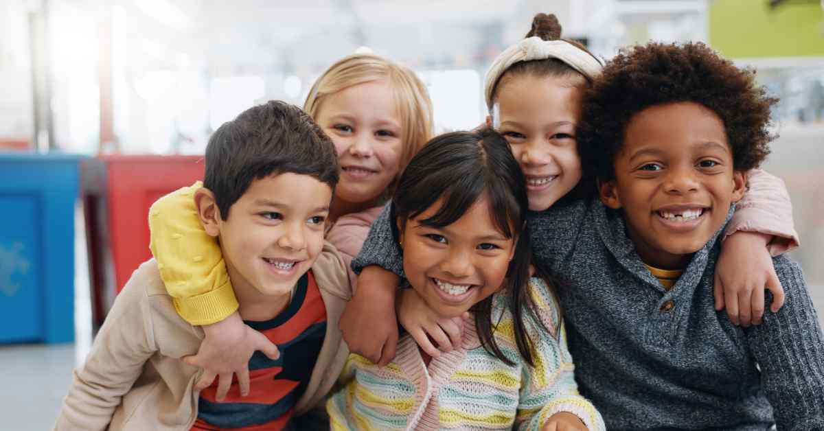 A group of children smile.