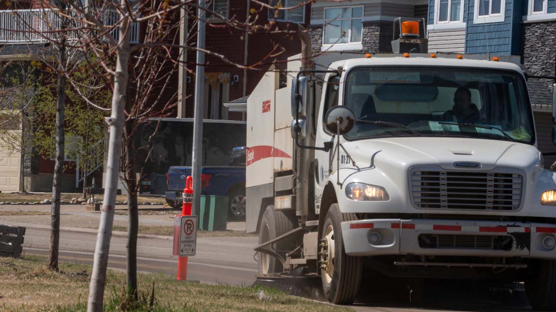 Street Sweeper next to temporary no parking sign