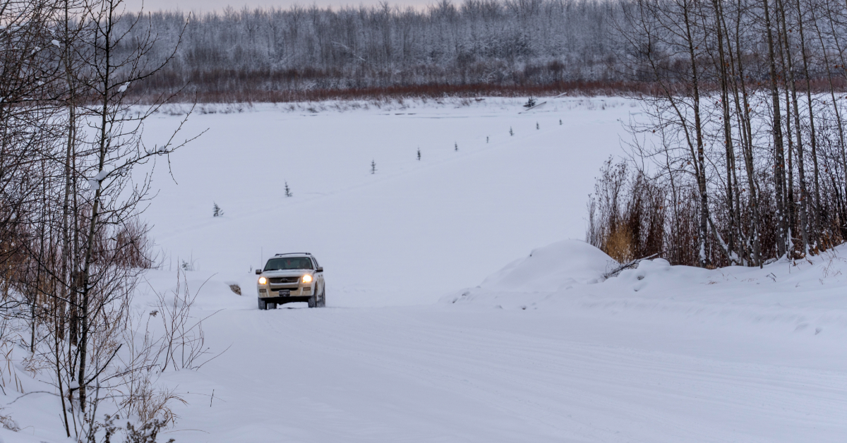 A vehicle drives on the Fort Chipewyan Winter Road.