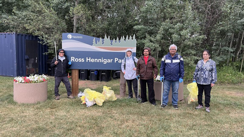 A community cleanup group poses with their collected trash