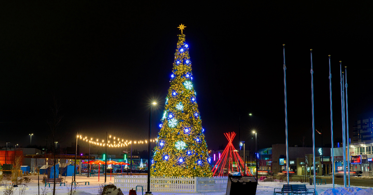 A picture of Kiyam Community Park with community holiday tree in the foreground and tipi in the background