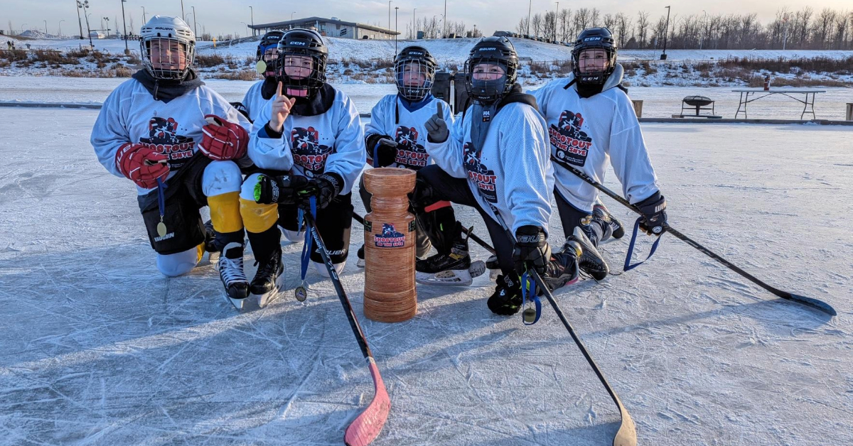 A winning team poses with the tournament trophy during the 2024 Shootout on the Snye.
