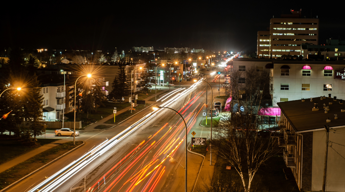 downtown at night with vehicles