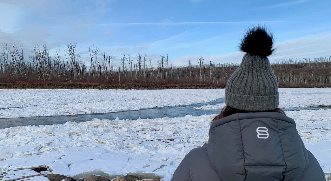 Woman watching ice on river