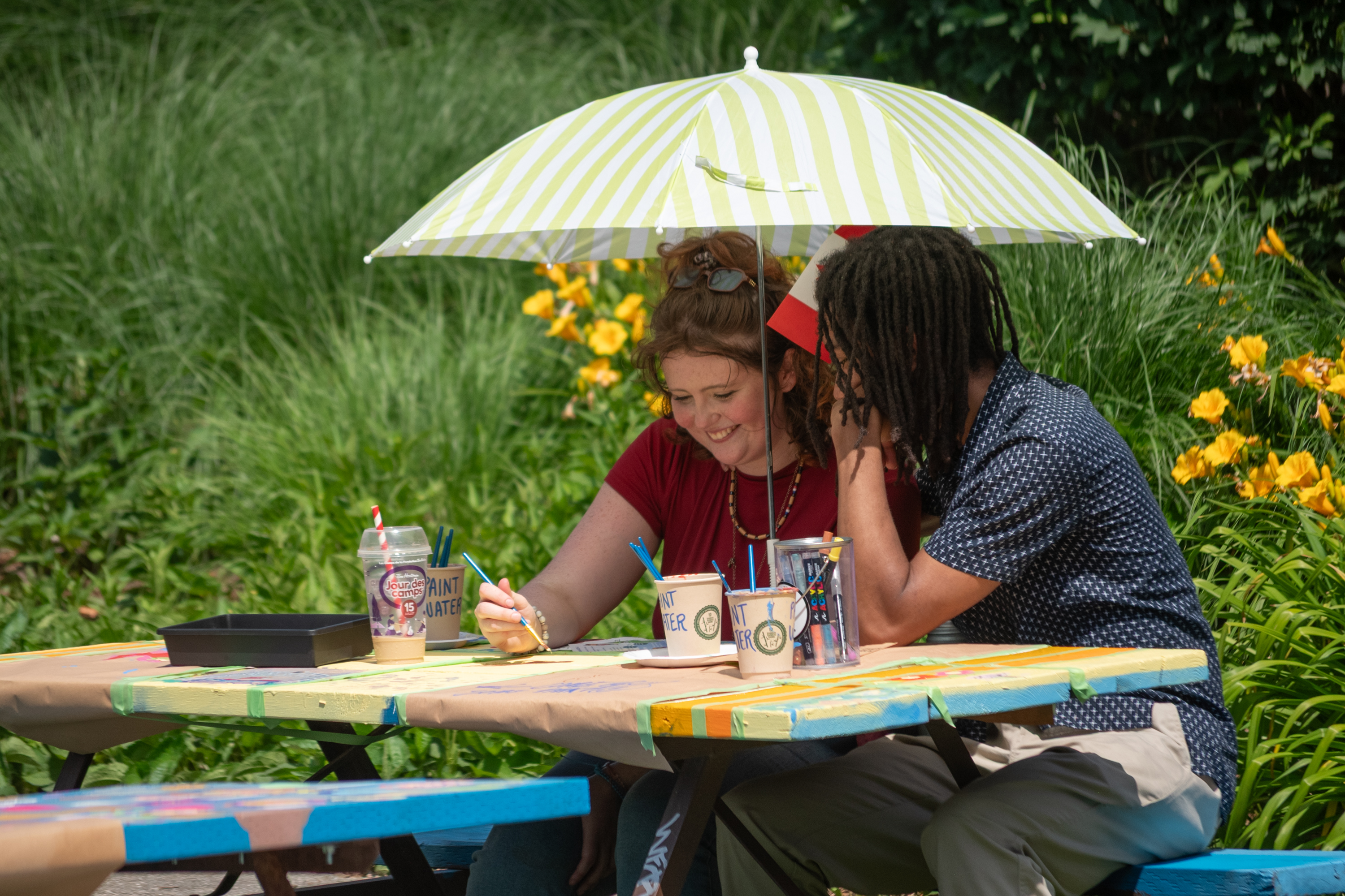 Staying in the shade while painting market square picnic tables