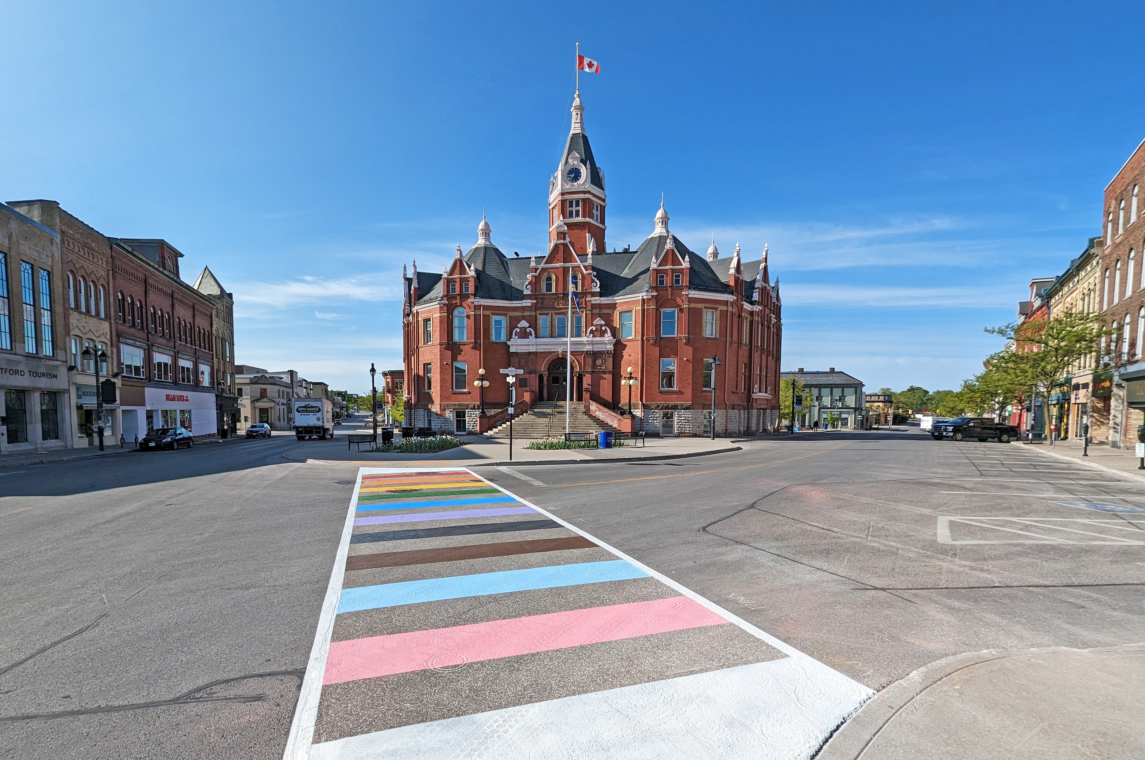 City Hall building with colourful rainbow crosswalk in front