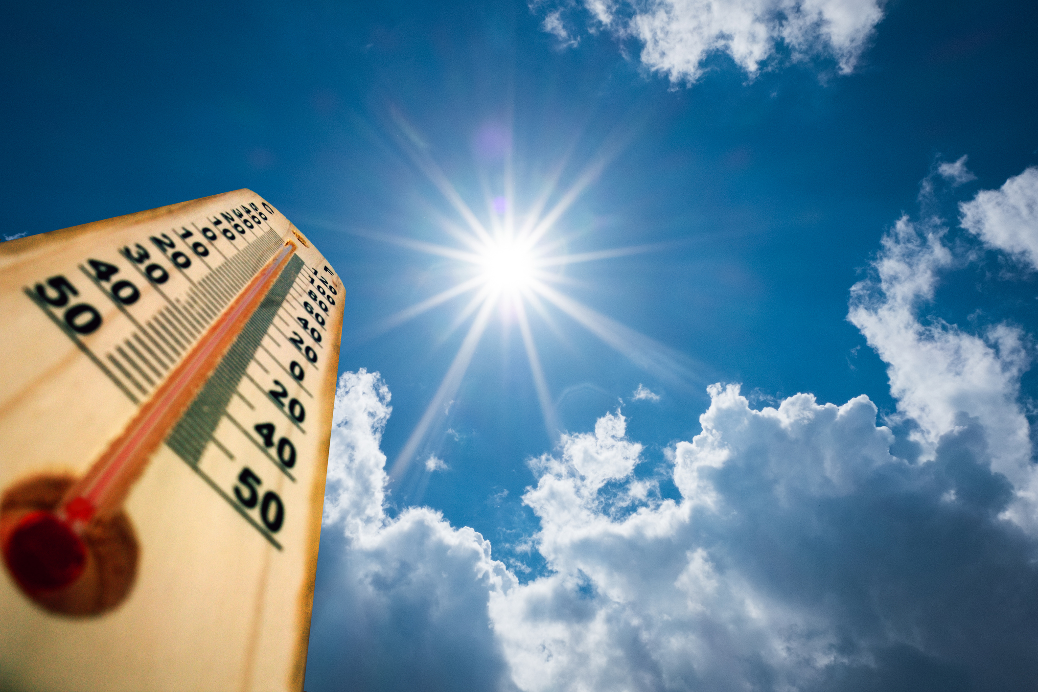 thermometer with the sun in the sky