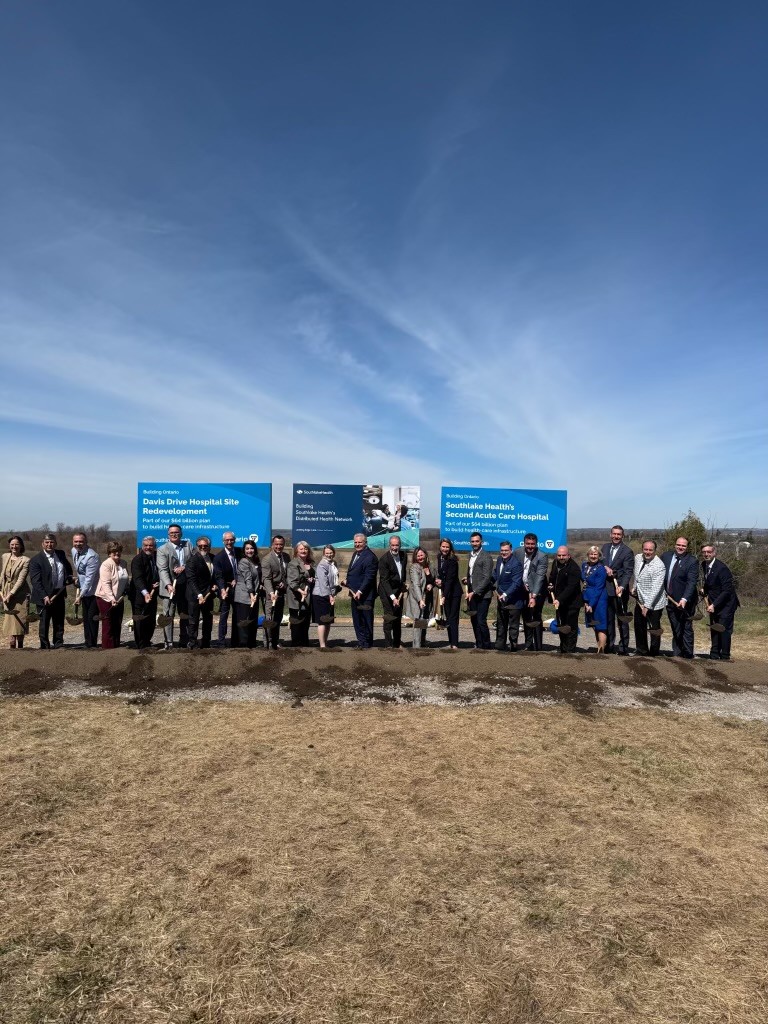 group of individuals standing in front of presentation signs for southlake development