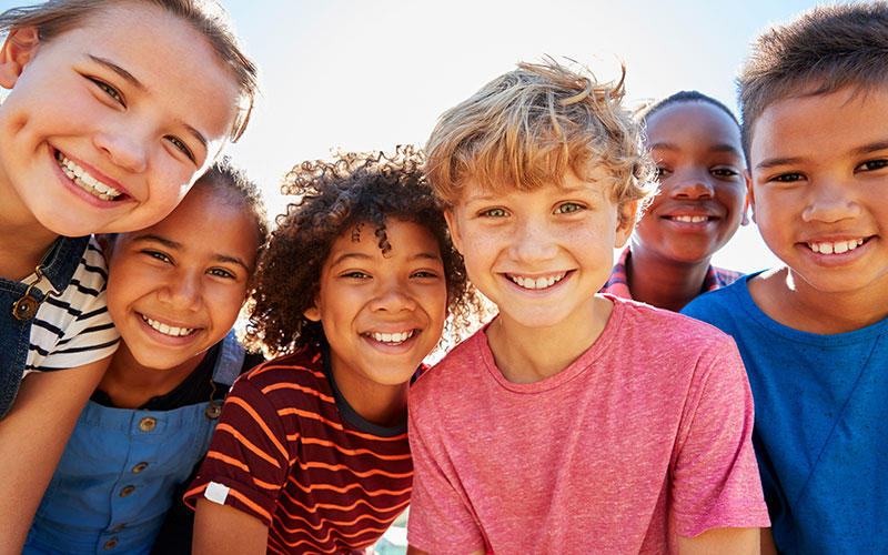 young kids smiling at the camera