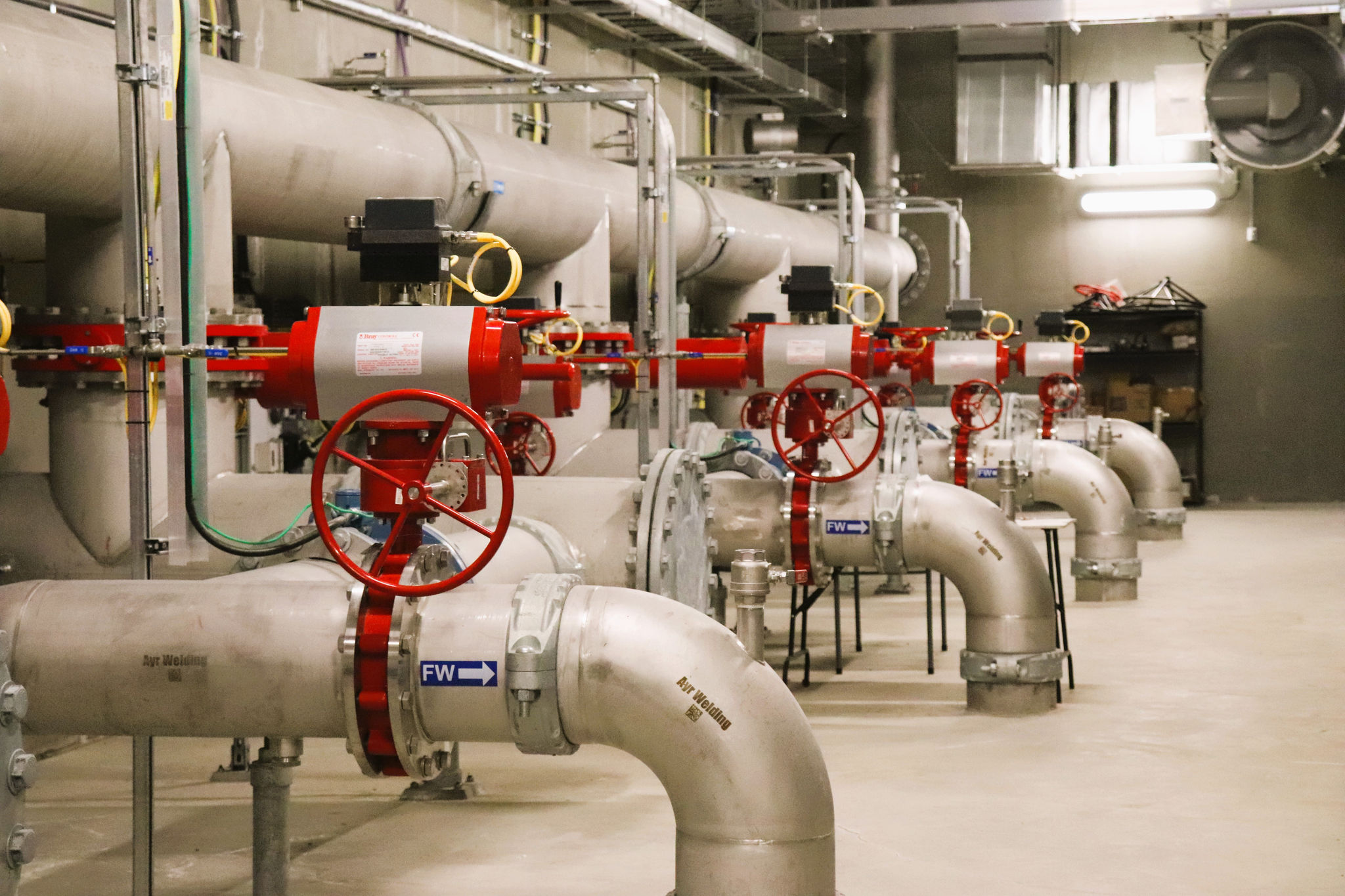 Large pipes and turnoff valves in a large water treatment facility.