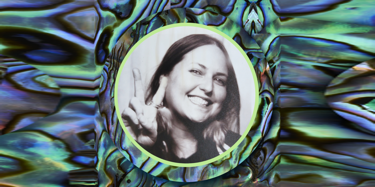 Woman giving the peace sign with a blue and green background