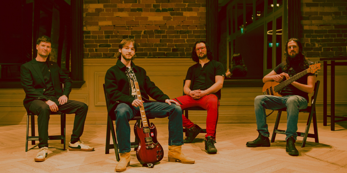 Four musicians sitting with instruments