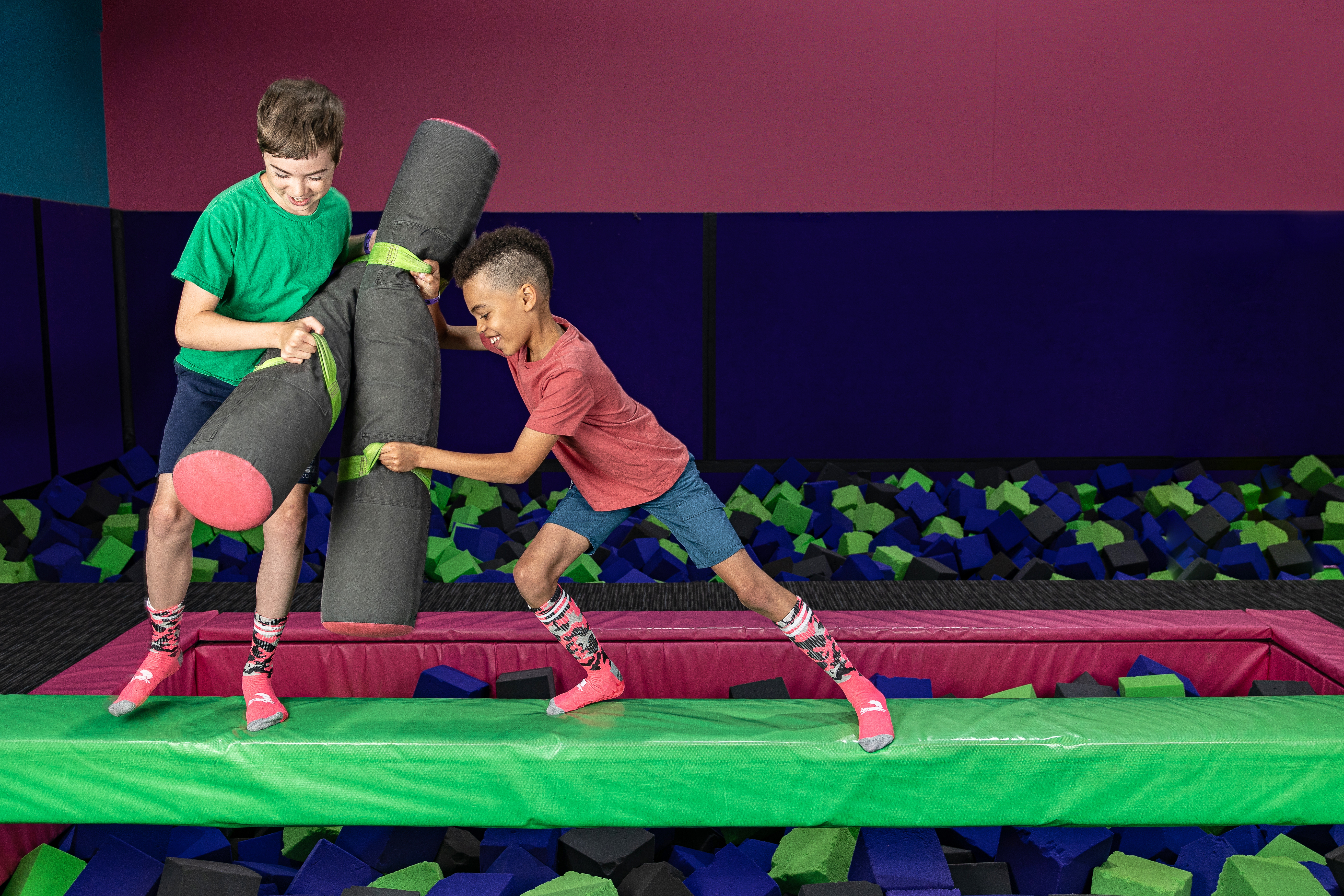 Two kids playing ninja warrior at Flying Squirrel Trampoline Park 