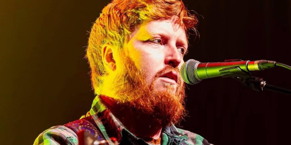 Jeremy standing at a microphone