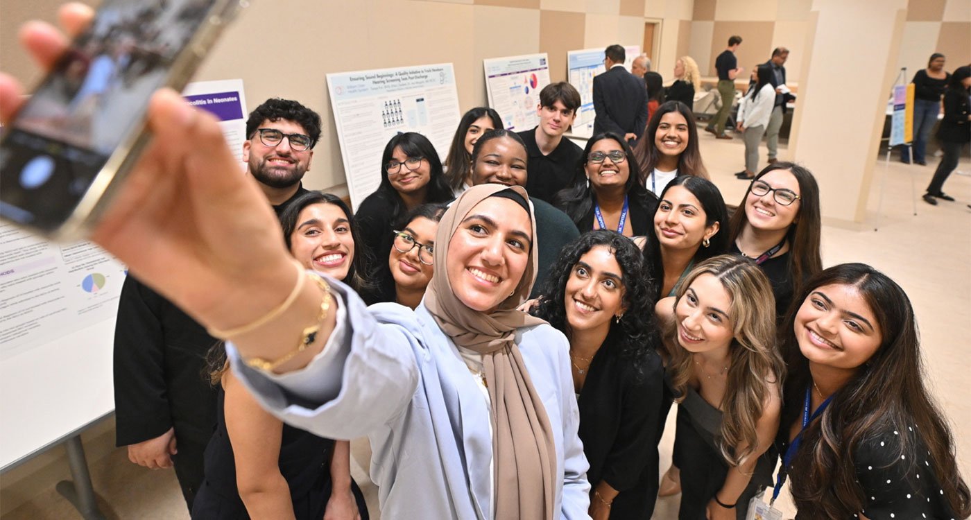 Students from the 2024 Summer Student Research Program take a group selfie